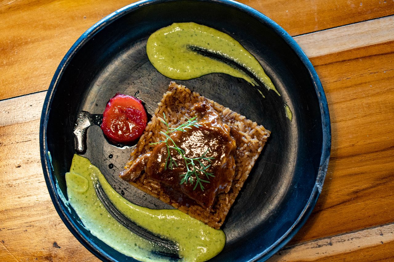 Posta Cartagenera served with coconut rice and fried plantain