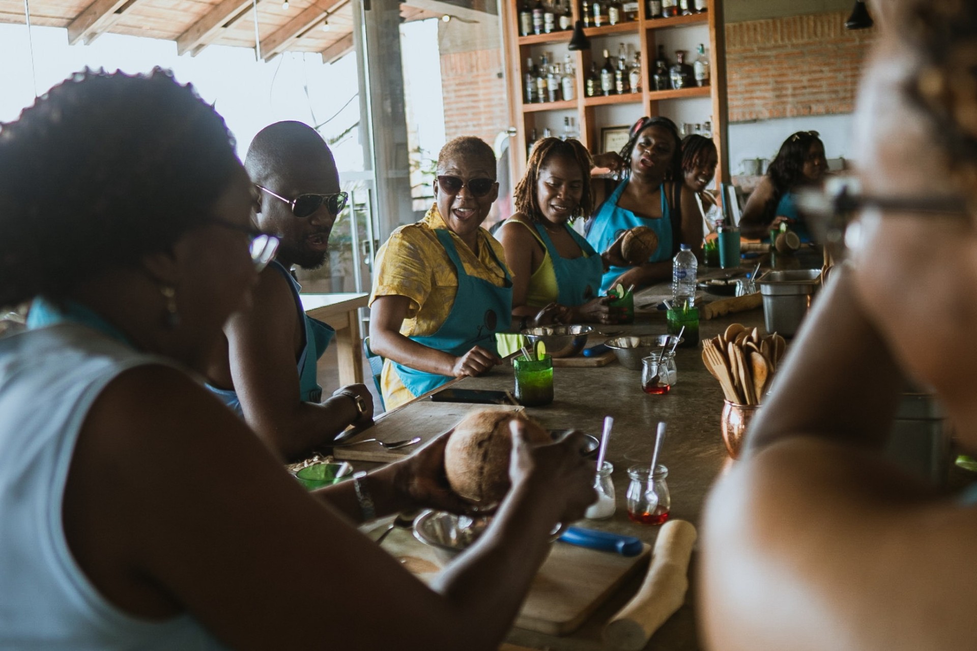 Guests around the Lunático kitchen counter during the cooking class
